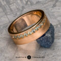 The "Linus" ring in 20k pink gold with a brushed texture and green Montana sapphires