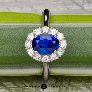 The Pave "Valeria" ring in platinum showcases a 1.41-carat Ceylon sapphire accented by pavé diamonds, beautifully displayed on a green leaf.