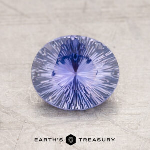 Displayed on a textured surface, a round 1.76-Carat Ceylon Sapphire with intricate facets captures the eye while the words "Earth's Treasury" appear at the bottom.