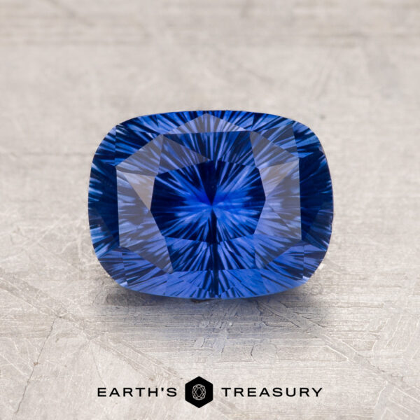 A close-up image of a 1.97-carat Ceylon Sapphire with intricate internal patterns, set against a textured gray background. Text at the bottom reads "EARTH'S TREASURY.