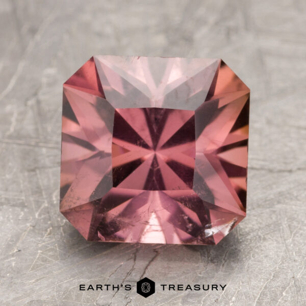 3.81-Carat Mauve-Pink California Tourmaline Square-cut pink gemstone labeled "ET1357" at the bottom. The stone is placed on a textured gray surface.
