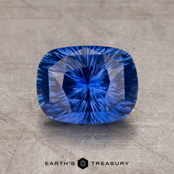 1.97-Carat Rich Blue Ceylon Sapphire (Heated) A close-up image of a 1.97-carat Ceylon Sapphire with intricate internal patterns, set against a textured gray background. Text at the bottom reads "EARTH'S TREASURY.