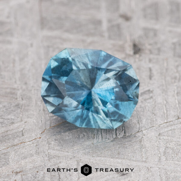 1.05-Carat Nasarawa Teal Aqua A 1.05-carat Nasarawa Teal Aqua gemstone displayed on a textured surface.