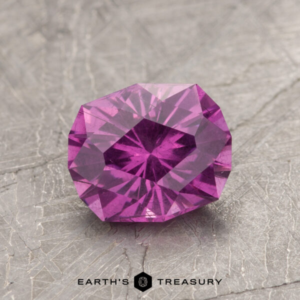 1.70-Carat Pastel Pyrope Color-Change Garnet A faceted ET1123 gemstone in purple rests on a textured gray surface.