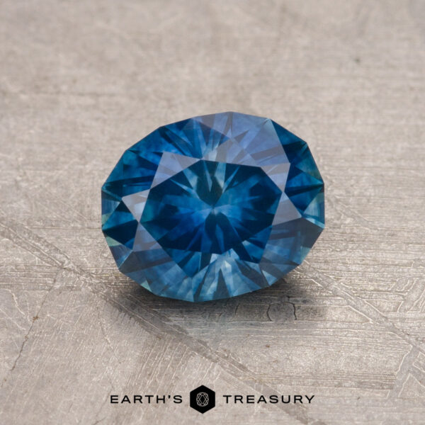 1.29-Carat Montana Sapphire (Heated) A 1.29-carat Montana sapphire (heated) displayed on a textured surface.