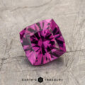 The ET1993 gemstone, with its intricate facets, rests on a textured gray surface.