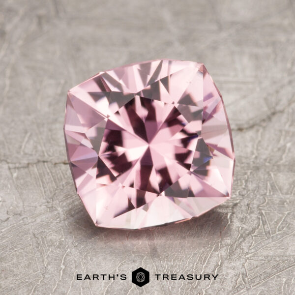 1.88-Carat Pink Tourmaline A square-cut gemstone with intricate facets rests on a textured surface, featuring the Earth's Treasury logo at the bottom.