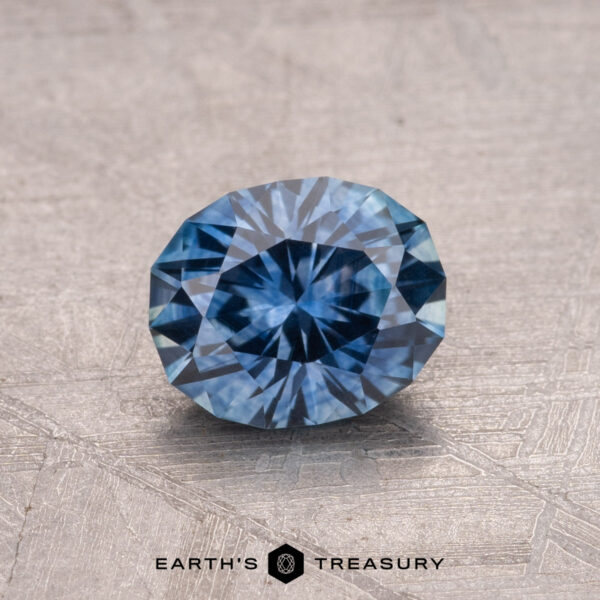 1.18-Carat Montana Sapphire (Heated) A faceted 1.18-carat Montana sapphire (heated) displayed on a textured surface.