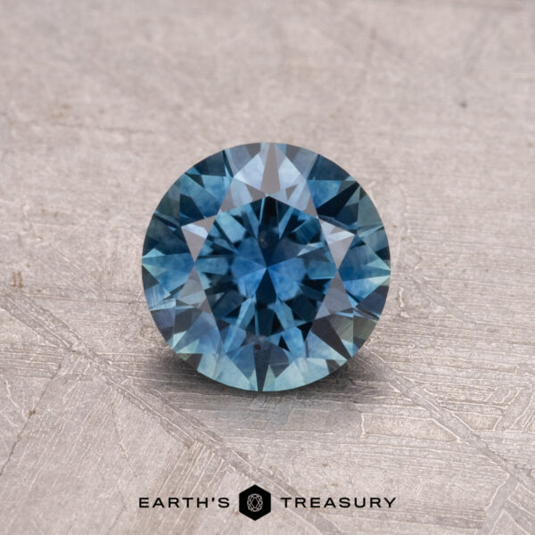 1.01-Carat Montana Sapphire (Heated) A 1.01-carat heated Montana sapphire from Earth's Treasury displayed on a textured surface.