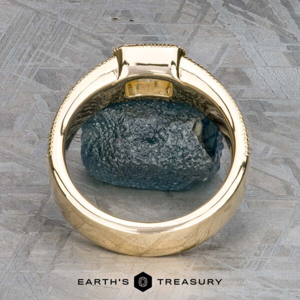 The "Augusta" ring in 14k yellow gold with 1.01-carat diamond The "Augusta" ring in 14k yellow gold with a 1.01-carat diamond stands upright, highlighting its smooth band and diamond setting against a textured background, with "Earth's Treasury" at the bottom.