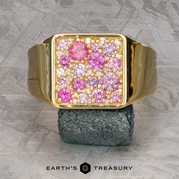 The Whitaker ring in 18k yellow gold with unheated pink sapphire Introducing The Whitaker Ring in 18k yellow gold: a captivating piece with a square top adorned with unheated pink sapphires and clear gemstones on a textured background. This exquisite creation is a timeless blend of elegance and sophistication, perfect for any occasion.