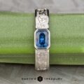 The "Kittley" ring in platinum, featuring a 0.80-carat Montana Sapphire, is displayed on a green stem with the "Earth's Treasury" logo below.