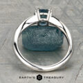 The Marlowe Ring is shown upright before a rough blue stone on a patterned gray surface, with “EARTH'S TREASURY” displayed at the bottom.