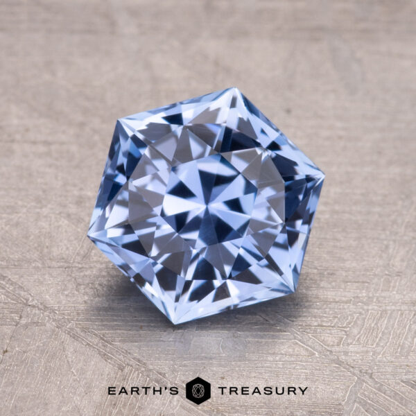 2.03-Carat Ceylon Sapphire A 2.03-carat Ceylon sapphire set on a textured gray background with "EARTH'S TREASURY" displayed beneath it.