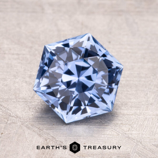 2.03-Carat Ceylon Sapphire A 2.03-carat Ceylon sapphire set on a textured gray background with "EARTH'S TREASURY" displayed beneath it.