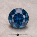 A 2.07-carat Montana sapphire (heated) sits on a textured surface, with "Earth's Treasury" below.