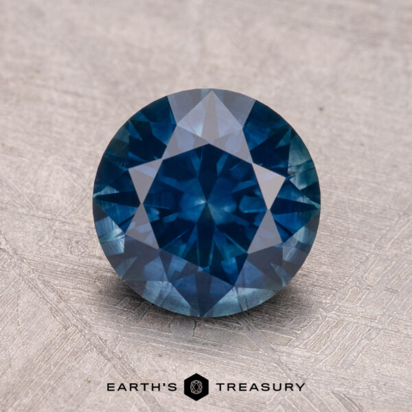 2.07-Carat Montana Sapphire (Heated) A 2.07-carat Montana sapphire (heated) sits on a textured surface, with "Earth's Treasury" below.