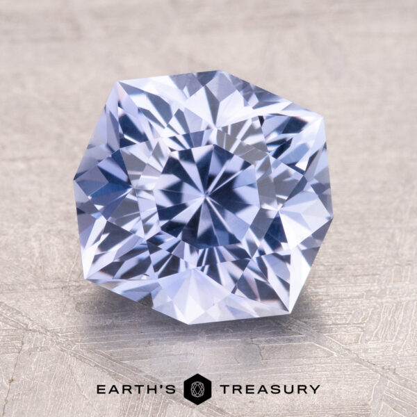 3.05-Carat Ceylon Sapphire 3.05-Carat Ceylon Sapphire, a faceted gemstone with a hexagonal shape on a textured surface. Text reads "Earth's Treasury" below.