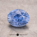 A 3.10-carat Madagascar Sapphire with intricate cuts is set against a plain background. The text "Earth's Treasury" appears at the bottom.