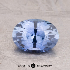 A 2.19-Carat Ceylon Sapphire with a round shape rests on a textured light surface.