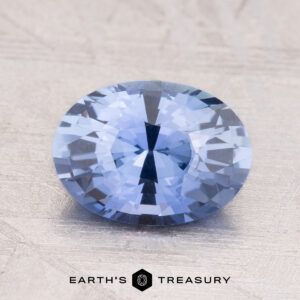 A 2.19-Carat Ceylon Sapphire with a round shape rests on a textured light surface.