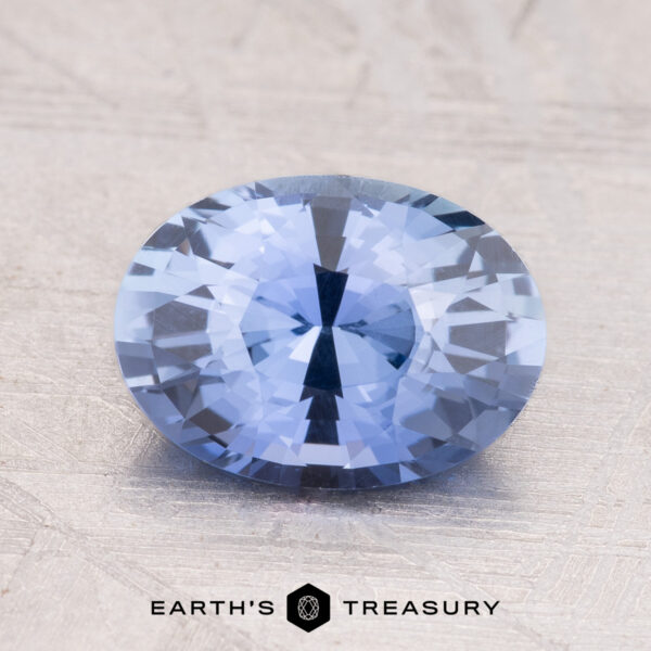 A 2.19-Carat Ceylon Sapphire with a round shape rests on a textured light surface.