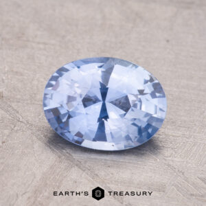 1.55-Carat Ceylon Sapphire placed on a textured surface.