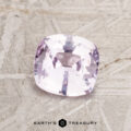 A 1.07-carat light pink Ceylon sapphire cushion-cut gemstone displayed on a textured surface with "Earth's Treasury" beneath.
