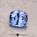 A 1.52-carat Ceylon Sapphire in a cushion cut rests on a textured surface.