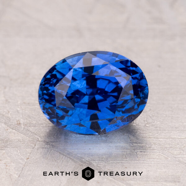 2.53-Carat Ceylon Sapphire (Heated) A 2.53-carat Ceylon sapphire with a faceted cut rests on a textured gray surface.