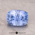 A 2.67-carat Ceylon Sapphire with internal patterns rests on a textured surface, with "Earth's Treasury" below.