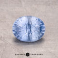 A 1.61-carat Ceylon Sapphire, faceted and round, features a light blue hue set against a textured background.