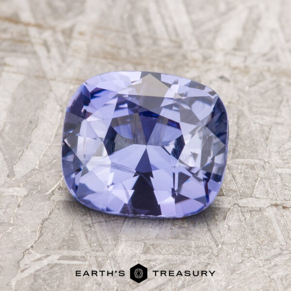1.91-Carat Violet Ceylon Sapphire A 1.91-carat cushion-cut violet Ceylon sapphire displayed on a textured surface.