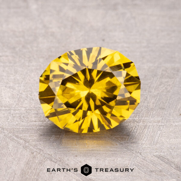 1.96-Carat Australian Sapphire (Heated) A 1.96-carat Australian sapphire (heated) with a round, faceted cut rests on a textured gray surface.