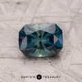 Blue-green faceted 1.40-carat Australian Sapphire with a textured surface; text reads "Earth's Treasury.
