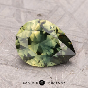 A pear-shaped, green gemstone with facets on a textured surface, labeled "2.49-Carat Australian Sapphire (Heated)".