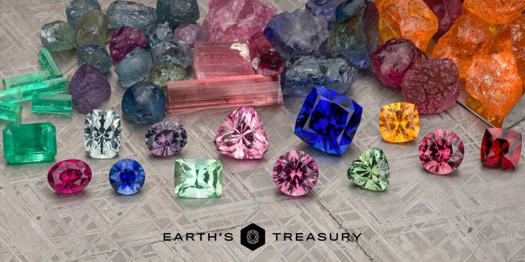 A variety of colorful gemstones, such as emeralds, sapphires, and rubies, laid out on a textured surface with the logo "Earth's Treasury." Product: All Gemstones.