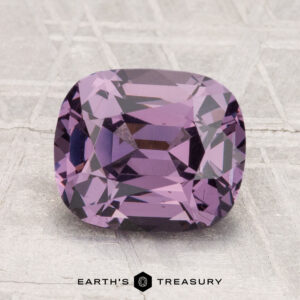 A 2.88-carat, cushion-cut purple Spinel gemstone is shown on a textured surface with the text "EARTH'S TREASURY" below it.