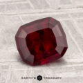 A 2.17-carat ruby is showcased on a light gray, textured background with the text "EARTH'S TREASURY" at the bottom.