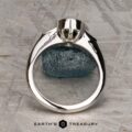 The "Ceres" ring in 14K white gold with a 2.52-carat Madagascar sapphire is displayed upright on a textured stone surface, featuring the Earth's Treasury logo at the bottom.