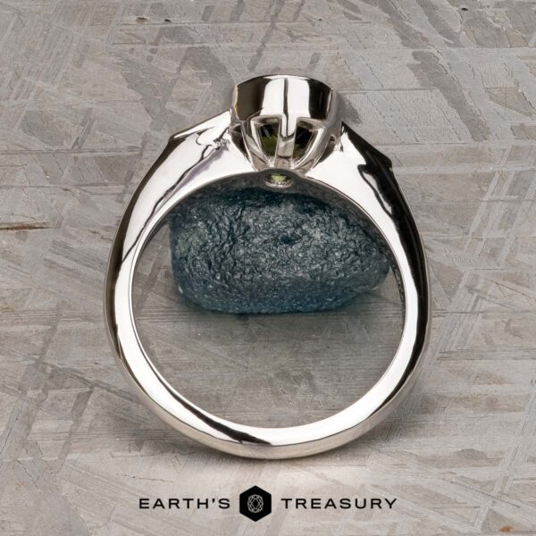 The "Ceres" ring in 14K white gold with 2.52-carat Madagascar sapphire The "Ceres" ring in 14K white gold with a 2.52-carat Madagascar sapphire is displayed upright on a textured stone surface, featuring the Earth's Treasury logo at the bottom.