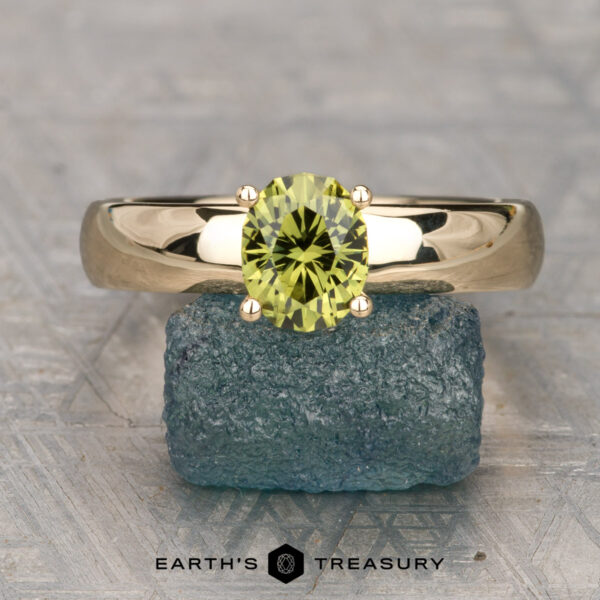The "Davina" ring in 14K yellow gold with 1.32-carat Australian sapphire The "Davina" ring in 14K yellow gold features a 1.32-carat Australian sapphire solitaire, shown standing on a blue stone with "Earth's Treasury" below—a signature design.