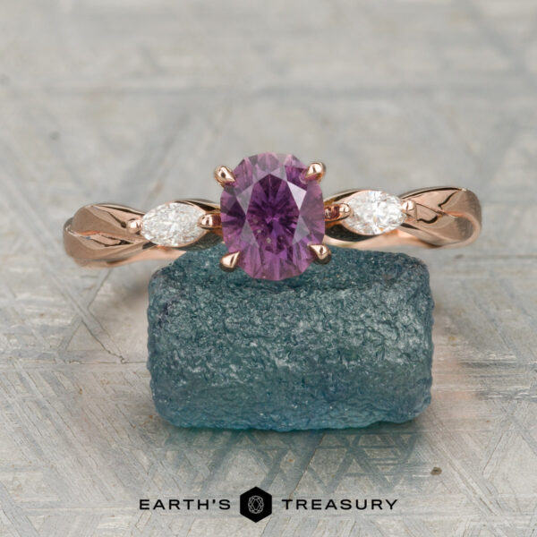 The Braided "Zuri" ring in 14K rose gold with 0.96-carat Umba sapphire The Braided “Zuri” ring in 14K rose gold showcases a 0.96-carat Umba sapphire center, flanked by pear-shaped diamonds in a stunning three-stone design.