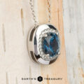 Showcasing the "Cirrus" Pendant in platinum with a 1.72-carat Montana sapphire, this elegant necklace stands out against a light, textured background. Build Your Own unique style with its stunning blue centerpiece.