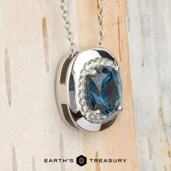 The BYO "Cirrus" pendant in platinum with 1.72-carat Montana sapphire Showcasing the "Cirrus" Pendant in platinum with a 1.72-carat Montana sapphire, this elegant necklace stands out against a light, textured background. Build Your Own unique style with its stunning blue centerpiece.