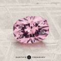 A 1.79-carat Mahenge Garnet with an oval cut and multiple facets is shown on a textured light gray surface, with the Earth's Treasury logo at the bottom.