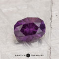 1.42-Carat Color Change Garnet, faceted oval gem shown on a textured light surface with "Earth's Treasury" at the bottom of the image.
