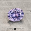A 1.37-carat heated Montana Sapphire gemstone is displayed on a textured gray surface, with “EARTH'S TREASURY” and a geometric logo beneath it.