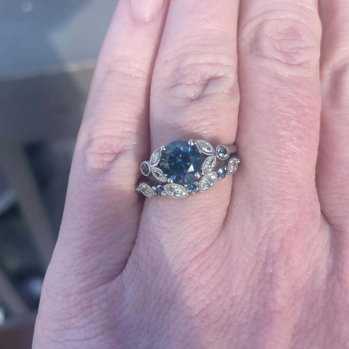 The "Calypso" ring in platinum with 2.10-carat Montana sapphire, alongside a custom sapphire "Thames" band in platinum