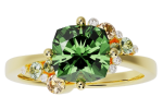 The ring-cluster is a gold ring with a prominent green gemstone in the center, accented by smaller clear and yellow stones on each side.